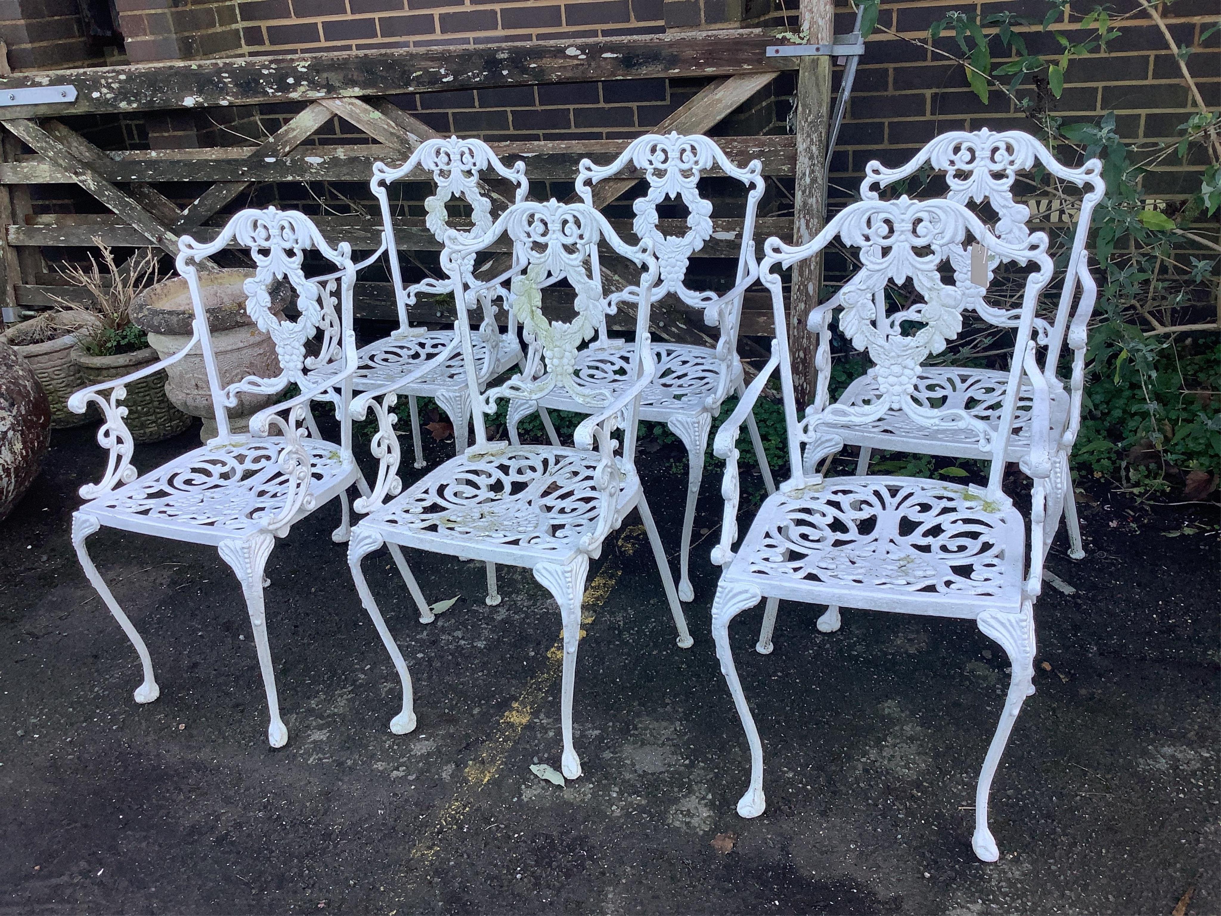 A white painted cast aluminium garden table, width 183cm, depth 92cm, height 71cm, and six chairs. Condition - fair